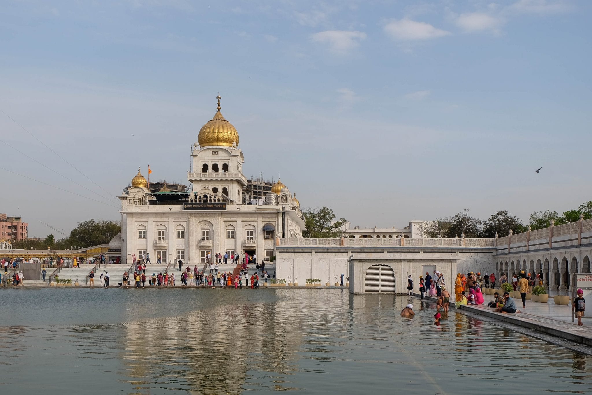 Gurudwara Bangla Sahib showcasing golden domes, sacred Sarovar, peaceful surroundings, and remarkable Sikh heritage in Delhi together.