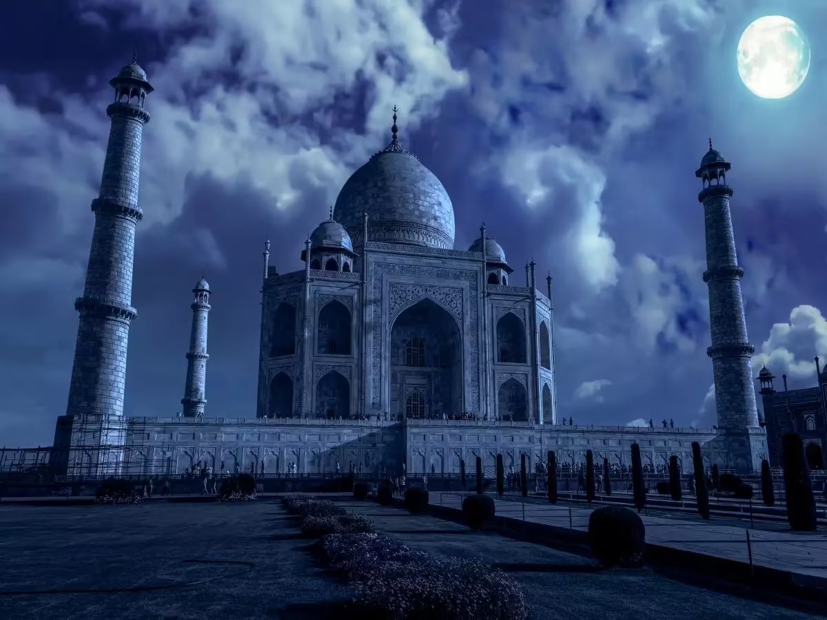 Taj Mahal glowing under moonlight with breathtaking white marble beauty and magical nighttime atmosphere in Agra together.