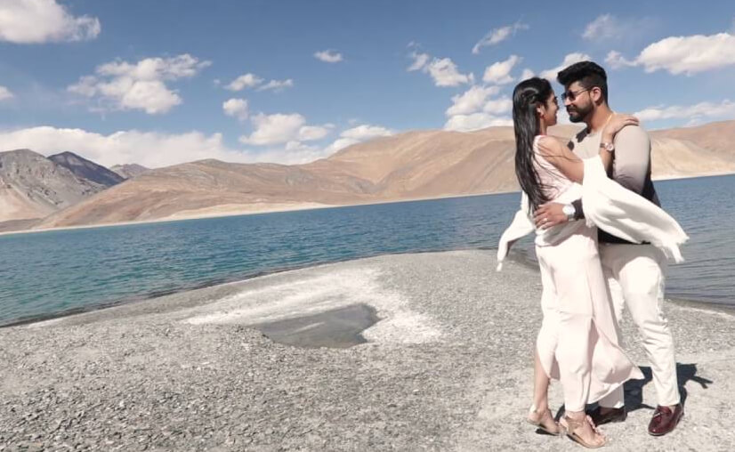 Couple embracing at Pangong Lake during honeymoon