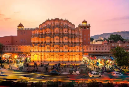 Hawa Mahal Jaipur illuminated at sunset with busy market street