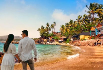 Romantic couple walking on beach in Goa during honeymoon