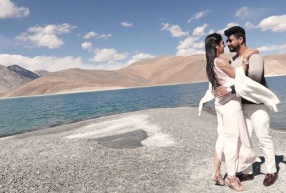 Couple embracing at Pangong Lake during honeymoon