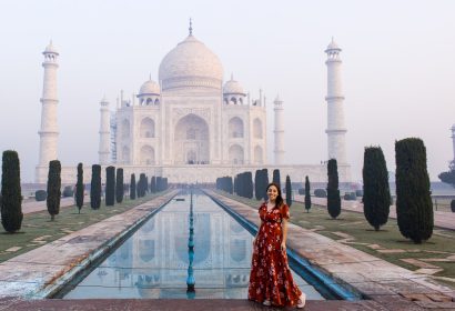 Woman posing at Taj Mahal during early morning visit