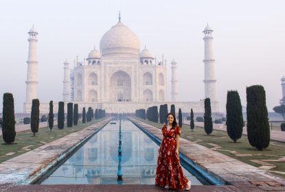 Woman posing at Taj Mahal during early morning visit